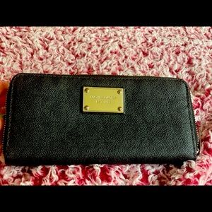 Gently loves black and silver large MK wallet.